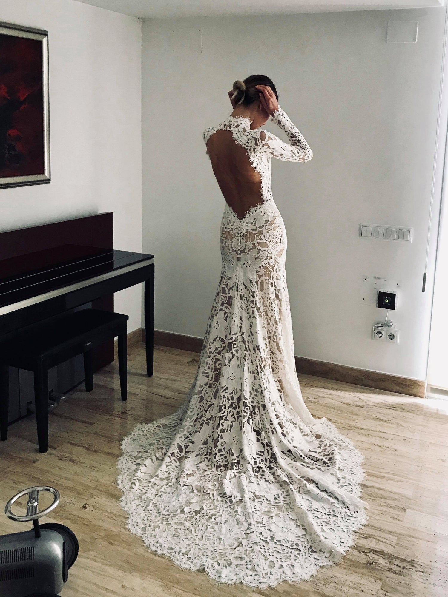 Bohemian lace wedding dress with turtleneck, open back and long sleevess.