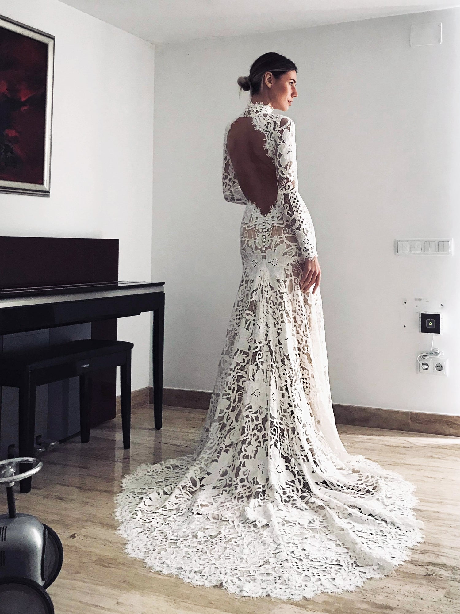 Bohemian lace wedding dress with turtleneck, open back and long sleevess.