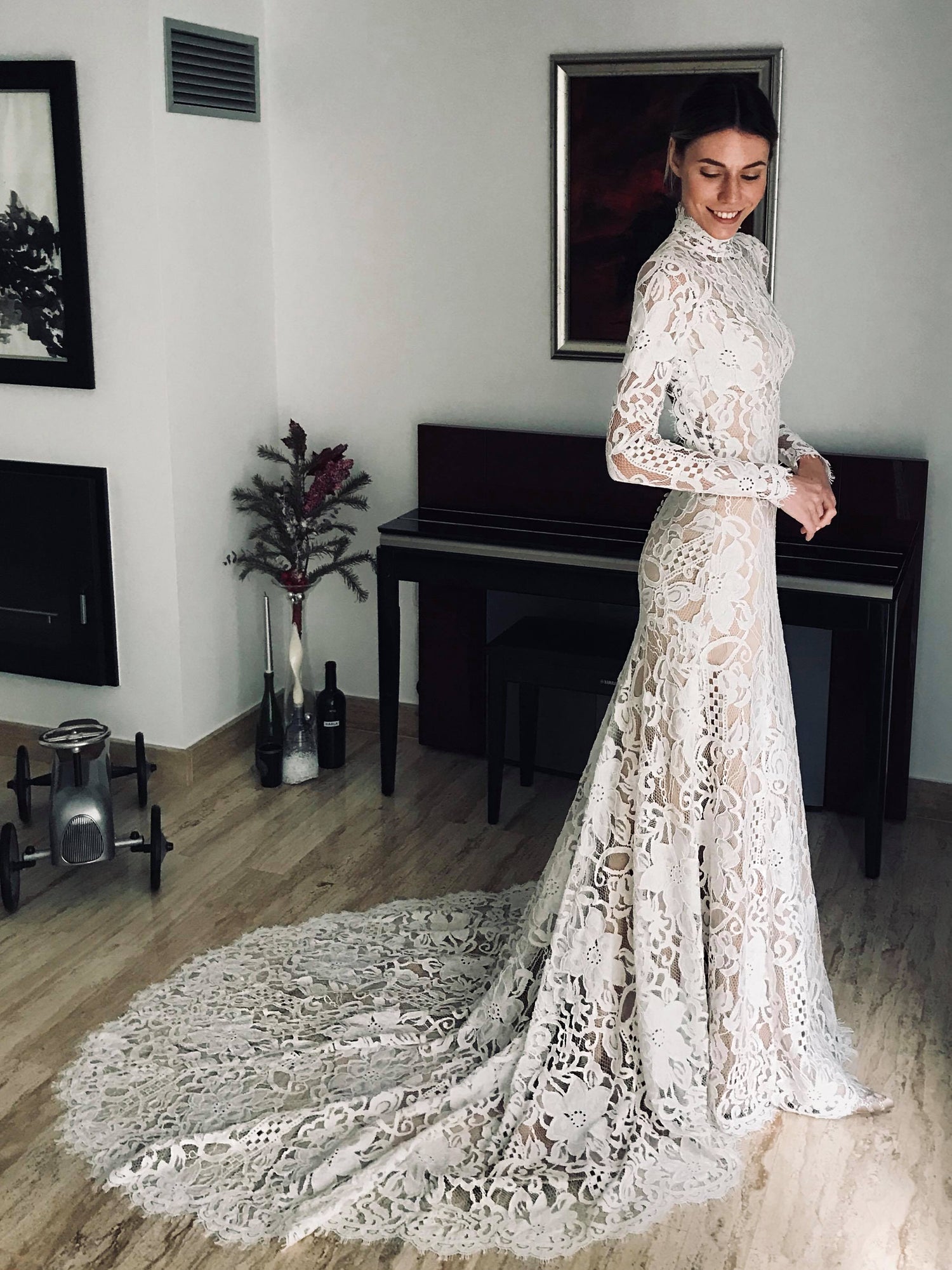 Bohemian lace wedding dress with turtleneck, open back and long sleevess.