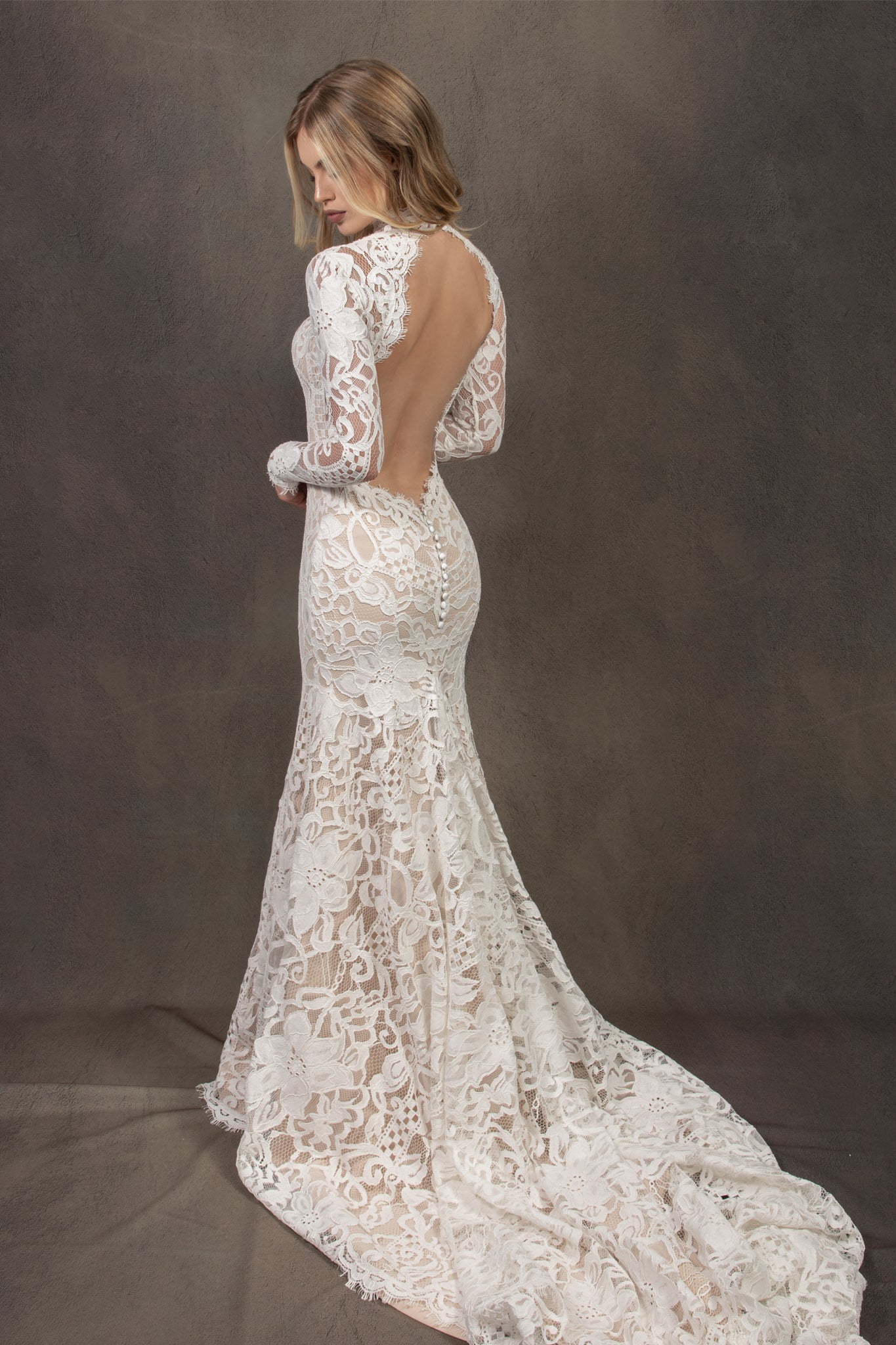 Bohemian lace wedding dress with turtleneck, open back and long sleevess.