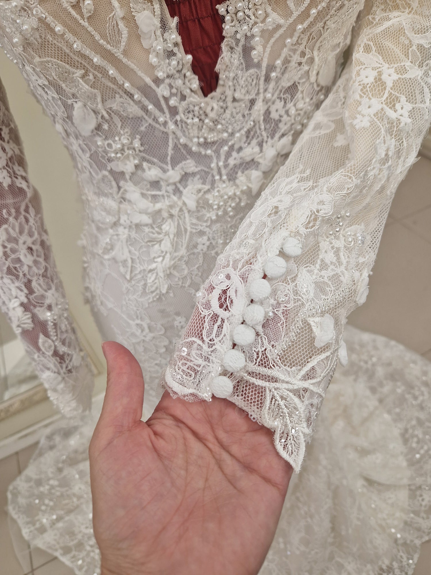 Beautiful detail at the sleeves of our lace wedding dress Amara - lace covered buttons at wrists.