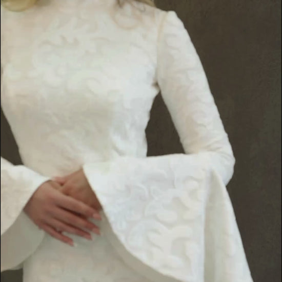 Winter lace wedding dress made in fit and flare silhouette. It's fully lined and has bell sleeves and turtle neckline.