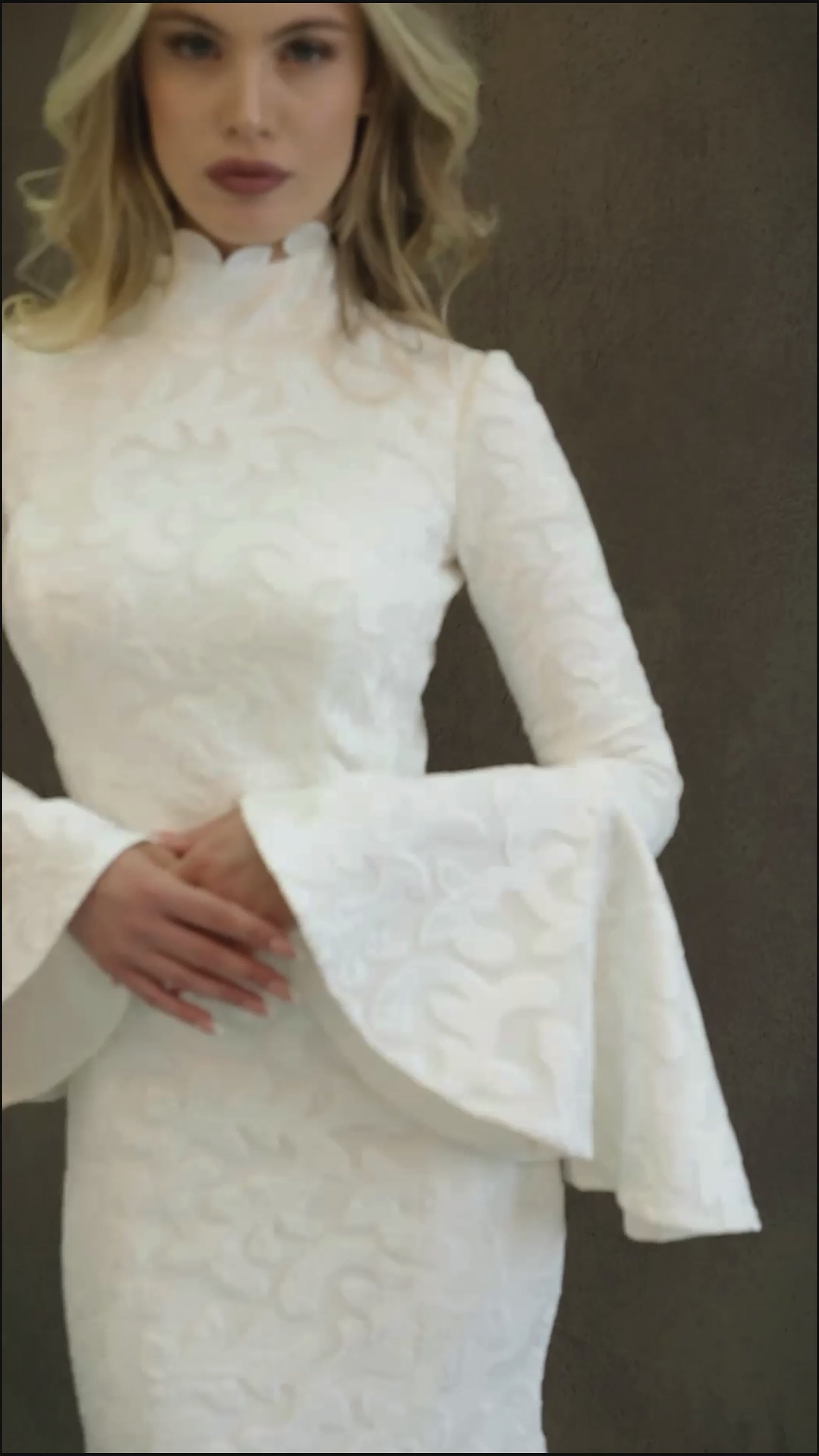 Winter lace wedding dress made in fit and flare silhouette. It's fully lined and has bell sleeves and turtle neckline.
